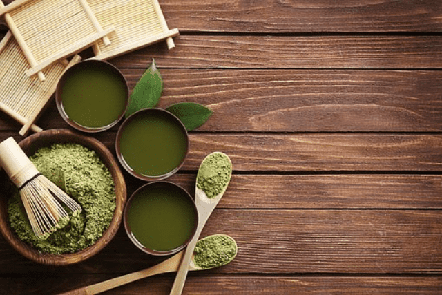 kratom in powder and liquid form on containers and spoons