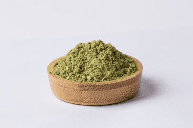 kratom powder on a clay pot