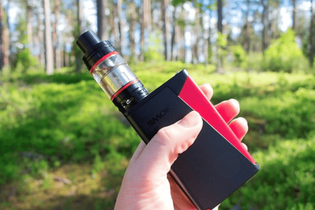 holding a vape full of eliquid