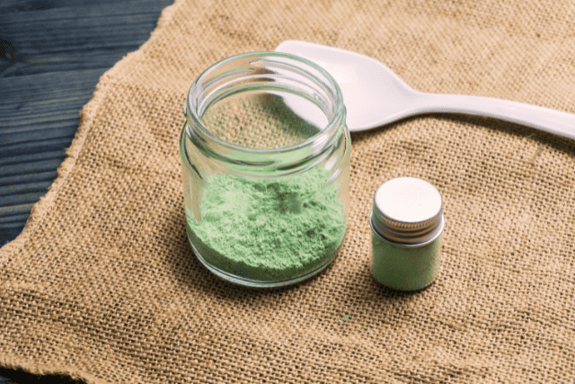 kratom powder on a glass container