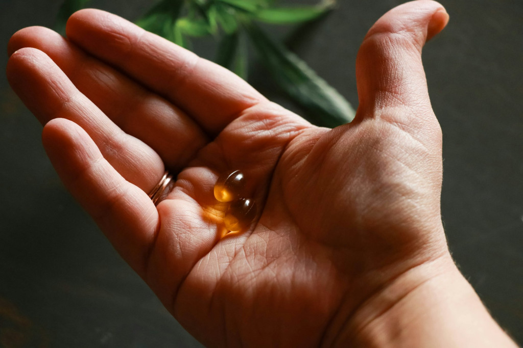 person with pills on hand