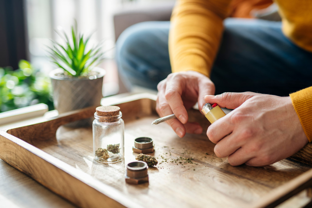 a guy holding a roll of weed