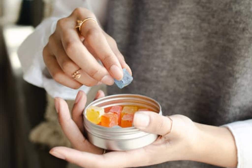 woman holding a box of gummies
